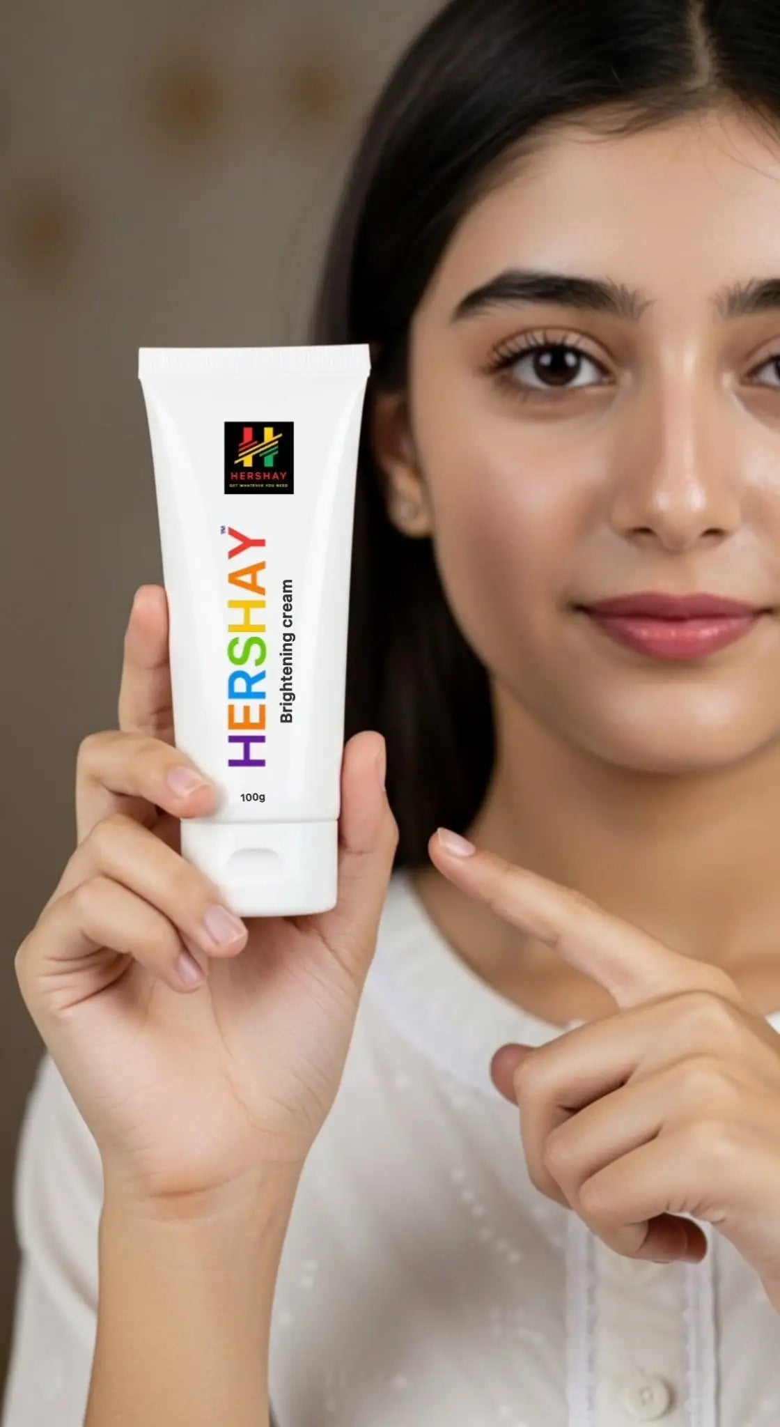 Woman holding a tube of Hershay brightening cream
