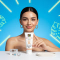 Woman holding a HERSHAY sunscreen tube with a blue background