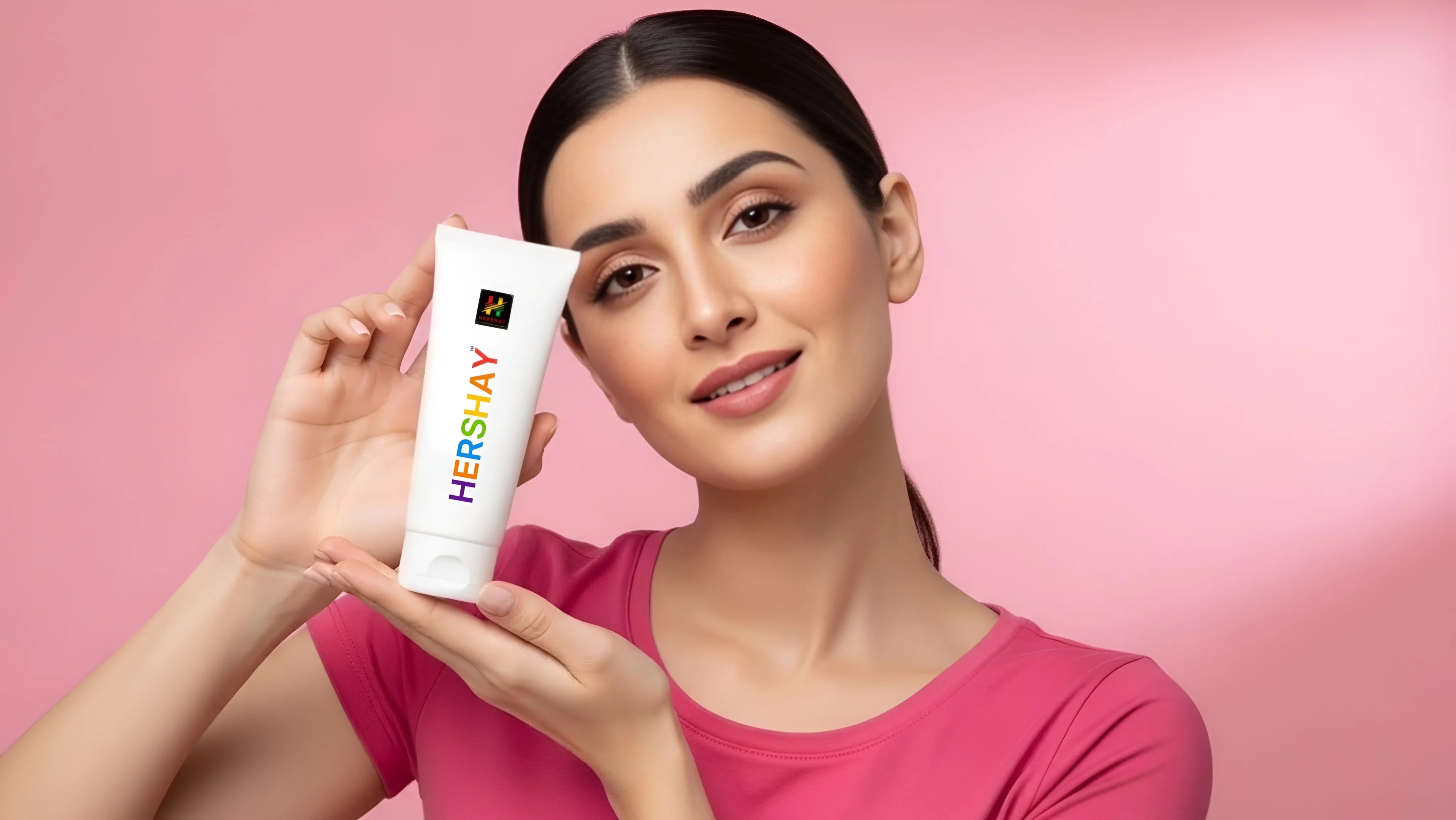 Woman holding a 'HERSHAY' product against a pink background

